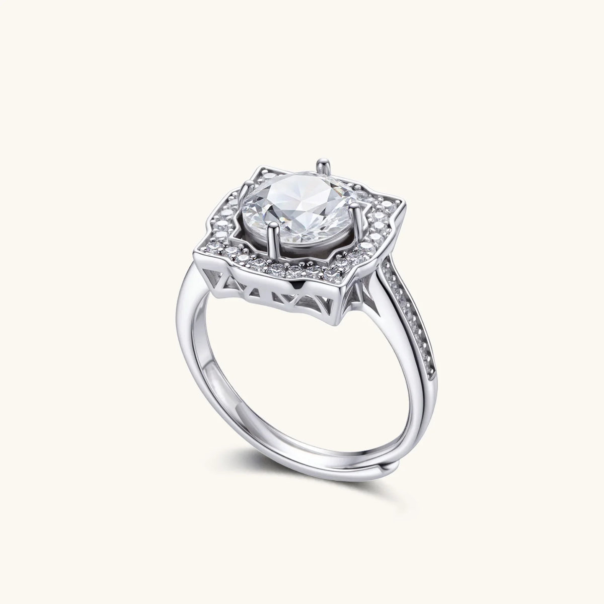 Sterling silver ring with round moissanite center stone in ornate scalloped halo setting on white background.