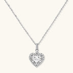 Sterling silver heart pendant necklace with brilliant moissanite center stone and halo setting on delicate chain