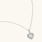 Sterling silver heart pendant necklace with brilliant moissanite center stone and halo setting on delicate chain