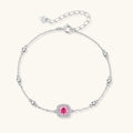 Elegant sterling silver chain bracelet featuring pink moissanite center stone in cushion halo setting with adjustable clasp