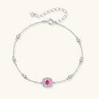 Sterling silver jewelry set featuring pink moissanite stones in halo settings on white background.