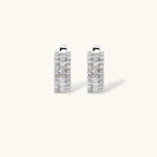 White gold plated necklace with vertical cubic zirconia pendant and matching hoop earrings on neutral background