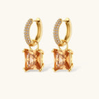 14K gold plated jewelry set featuring square champagne CZ stones with sparkling huggie earrings on cream background.