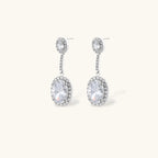 Elegant white gold plated jewelry set with oval cubic zirconia stones in halo settings, featuring Y-necklace and drop earrings.