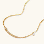 Gold-plated necklace with geometric diamond segments and matching huggie earrings featuring cubic zirconia details