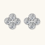 Dainty sterling silver quatrefoil stud earrings with four brilliant moissanite stones and center accent on white background.