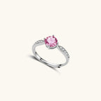 Brilliant pink moissanite ring in sterling silver 4-prong setting with accent stones on adjustable band