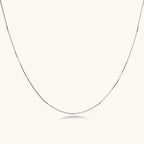 Delicate platinum-plated sterling silver necklace with alternating textured cubic links and smooth chain sections.