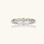 Platinum-plated copper ring with alternating clear and pale yellow oval stones in an eternity band design on white background.